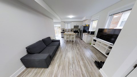 an open living room with a couch and a tv